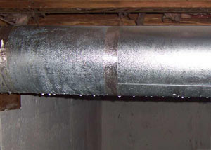 condensation collecting on an HVAC vent in a humid Glencoe basement